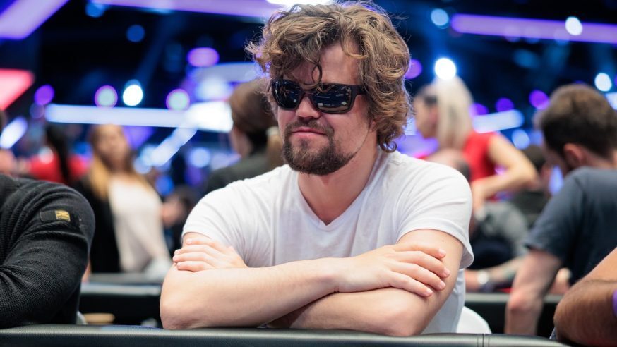 Magnus Carlsen playing poker with sunglasses on